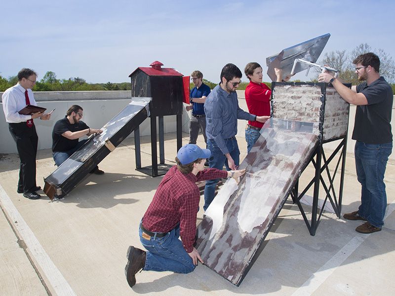 Engineering students work on solar dryers