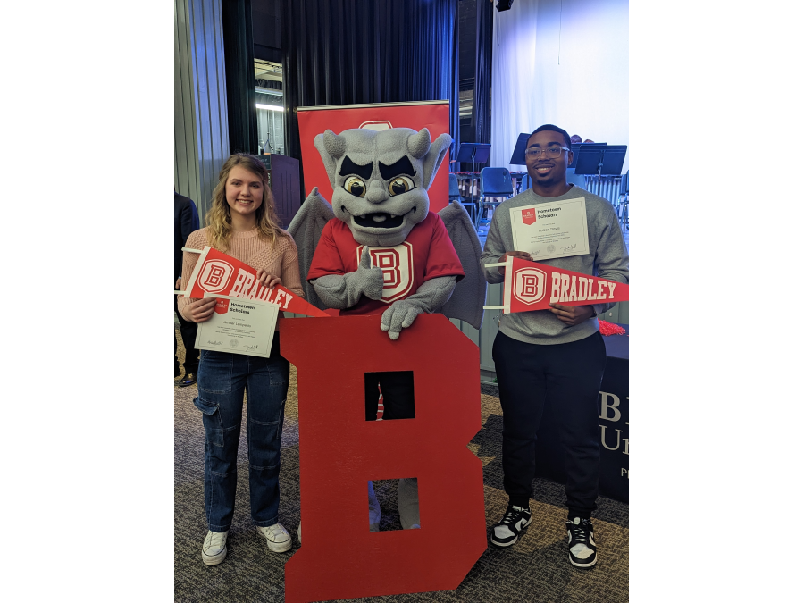 Richwoods High School seniors Kaizon Davis (psychology) and Amber Lempesis – (chemical engineering-chemistry) receive their Hometown Scholar awards from Bradley University at a surprise ceremony in the school auditorium.