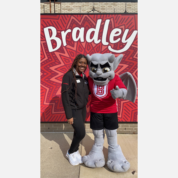 Photo of Kamia Berry with Bradley University's mascot KABOOM