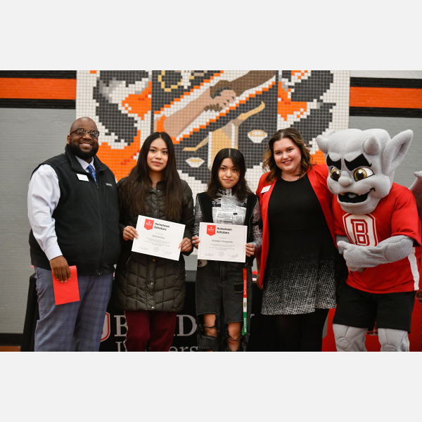 Manual High School students Naidelyn Osegueda (entrepreneurship) and Zulema Ruiz (civil engineering) receive their Hometown Scholar awards from Bradley University in a surprise presentation at Manual.