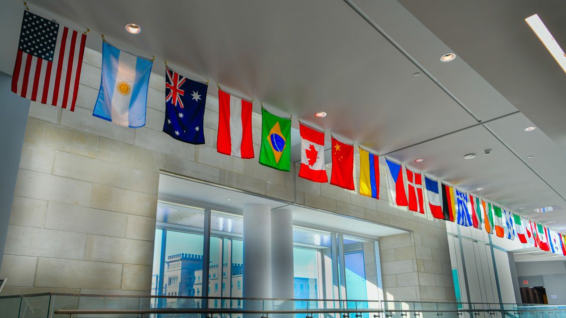 International flags hanging inside of the Business and Engineering Convergence Center.
