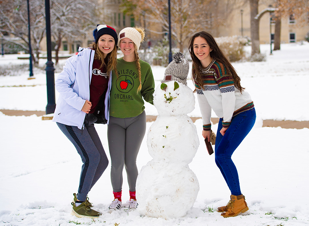 Three girls with snowman